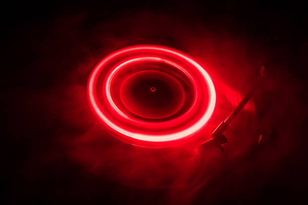 istock Turntable playing vinyl with glowing abstract lines concept on dark background 960791998