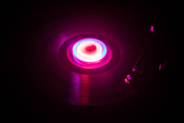 istock Turntable playing vinyl with glowing abstract lines concept on dark background 960792002