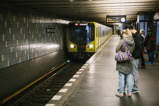 the berlin underground. people stand on the platform and wait for the train. - clock station people berlin germany imagens e fotografias de stock