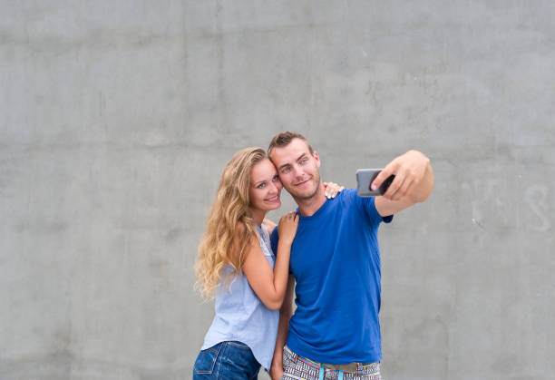istock Beautiful young couple taking selfie in park 960795240