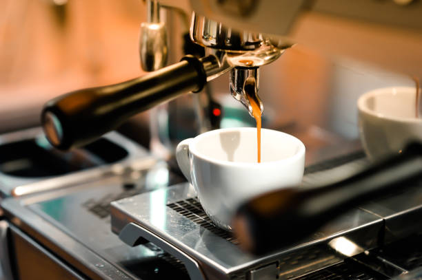 istock Concentrated coffee is flowing down from the automatic coffee machine to the measuring cup. 960797942