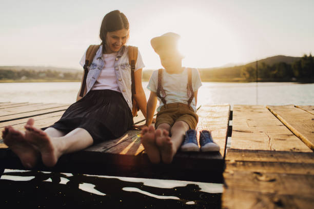 istock Mother and son on lake dock 960801992