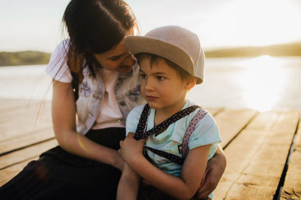 istock Mother and son on lake dock 960803174