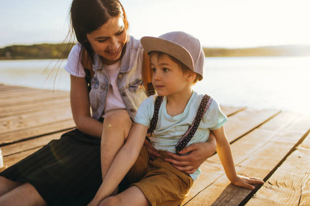 istock Mother and son on lake dock 960803226