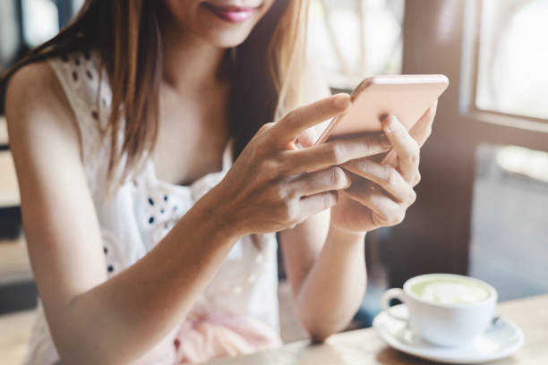 istock Young woman using smart phone in coffee shop 960805414