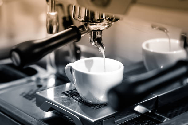 istock Concentrated coffee is flowing down from the automatic coffee machine to the measuring cup. 960808120