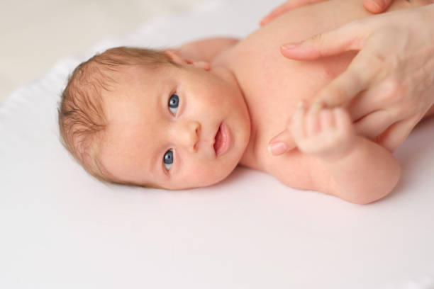 istock One month old newborn baby with mother 960824444