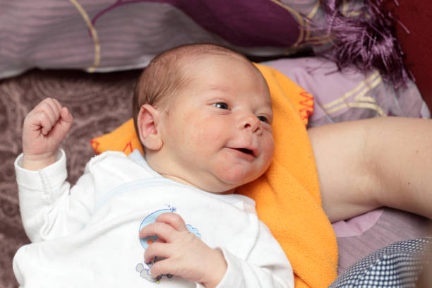 Portrait of a smiling newborn on a blanket
