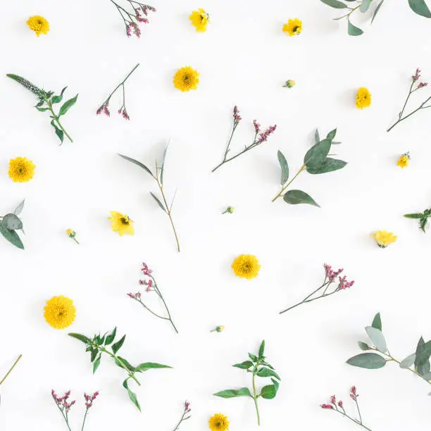 Flowers composition. Pattern made of yellow and pink flowers on white background. Flat lay, top view, square