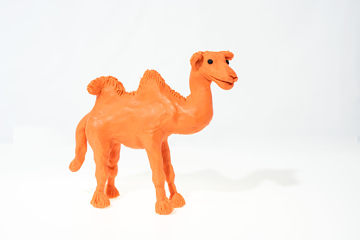 Plasticine artwork. Handmade camel. Abstract isolated photo.
