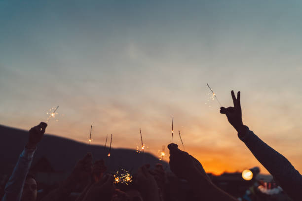 istock Friends on party holding sparklers at night 960850856