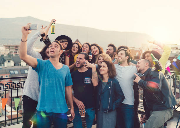 istock Friends taking selfie on rooftop party 960851278