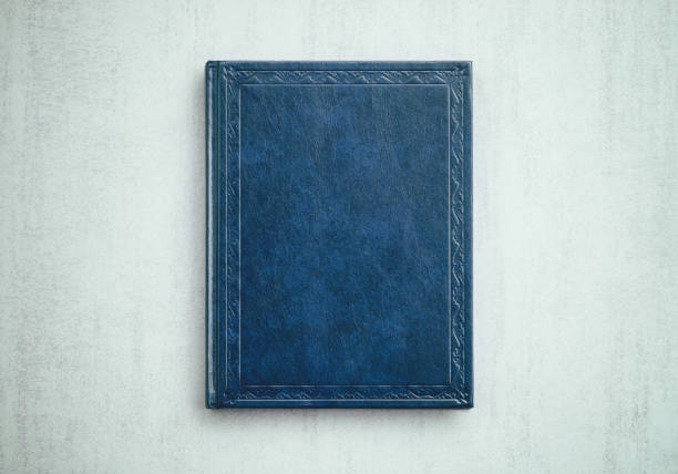 istock mock up book blue color on gray background close-up, top view 960851976