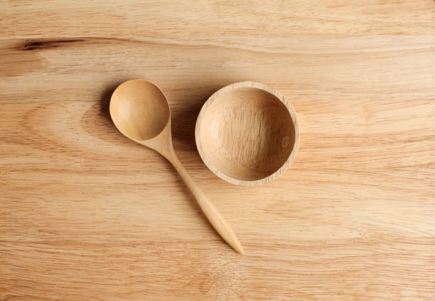istock small bowl and  two spoon made from wood on wood plate 960852034
