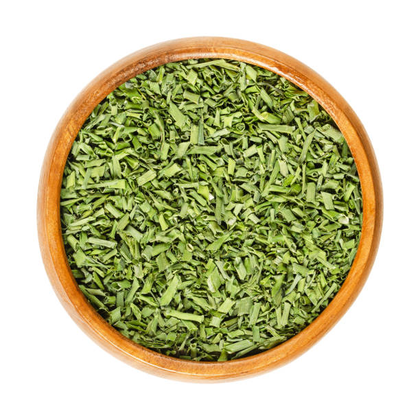 istock Dried chives in wooden bowl over white 960852580