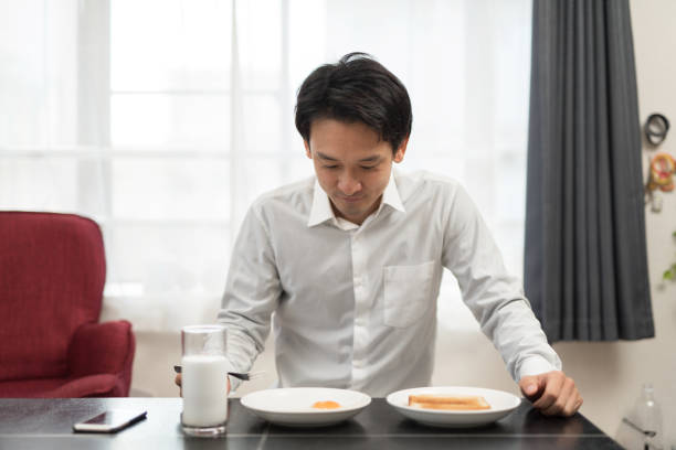 istock businessman eating breakfast in his house 960860538