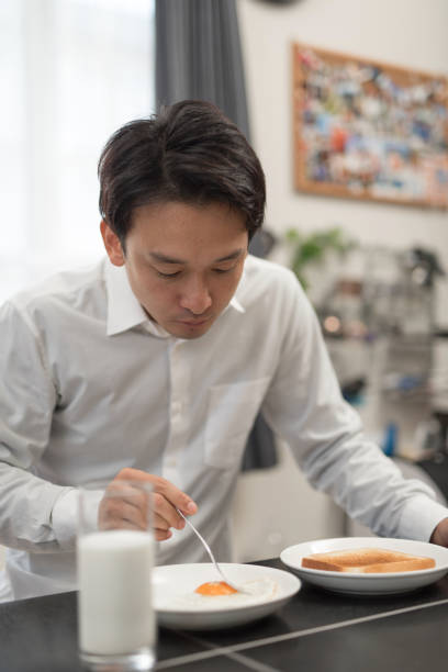 istock businessman eating breakfast in his house 960861502