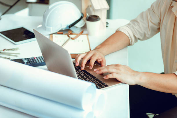 istock Close up portrait of civil engineer using laptop to  planning project schedule, Engineering and construction concept 960863240