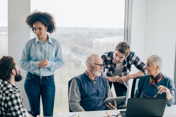 istock Coworkers of all ages talking at office 960865932