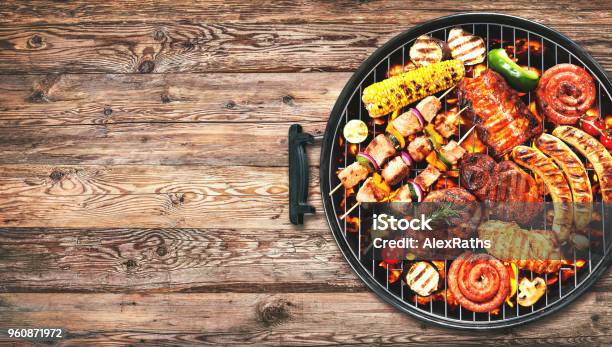Assorted Delicious Grilled Meat And Bratwurst With Vegetables On Grill Stock Photo - Download Image Now