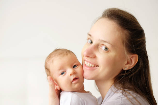 istock One month old newborn baby with mother 960872200