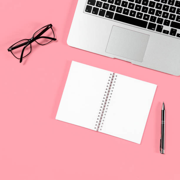 istock Minimal flat lay Laptop notebook glasses pink 960872560