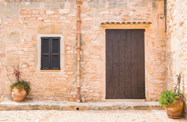 istock Mediterranean rustic stone house, front door and small window 960875382