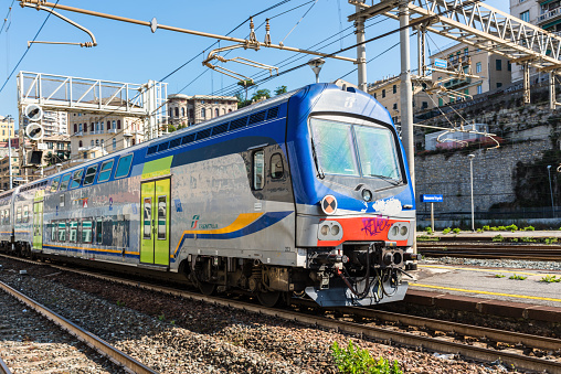 Genoa, Italy - May 15, 2017: Trenitalia passenger train arriving to the Genova Brignole railway station in Genoa, Liguria, Italy.