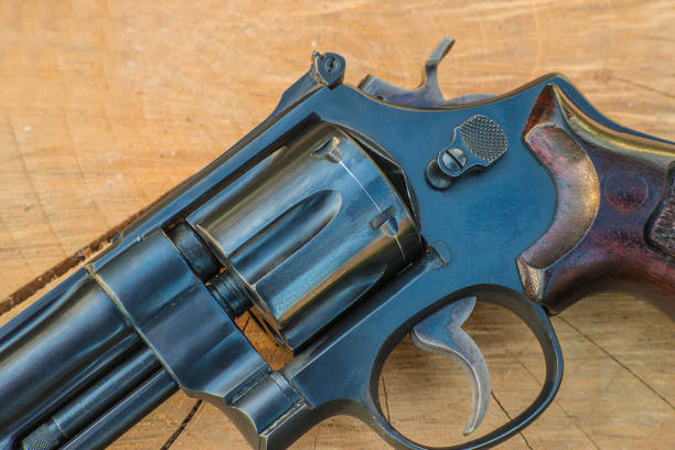 istock Handgun close up on wooden background 960885844