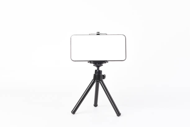 Mobile phone Mobile phone set on tripod for taking pictures,white isolated background. tripod stock pictures, royalty-free photos & images