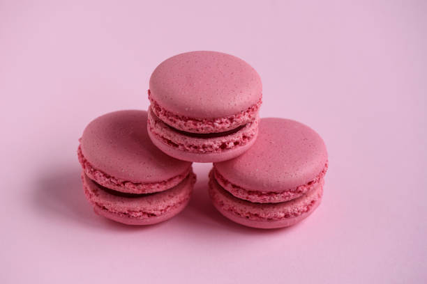istock Pink macaroons on pink background, homemade food 960897652