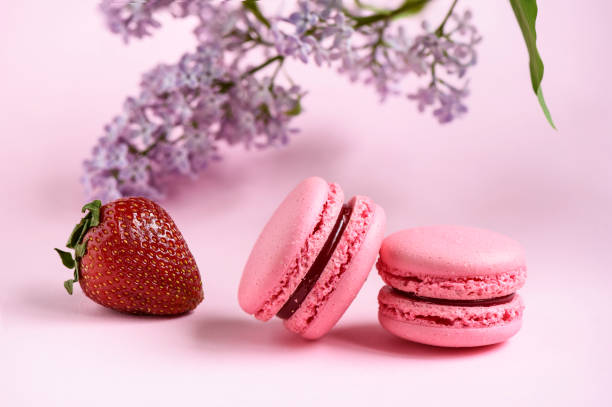 istock Selective focus two pink macaroons, a branch of lilac and strawberry 960897880