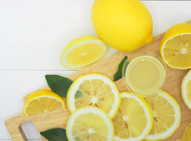 istock Fresh lemon slice with lemonade on white wood background 960901636