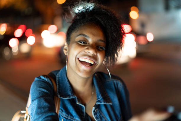 Afro young woman portrait in the city at night