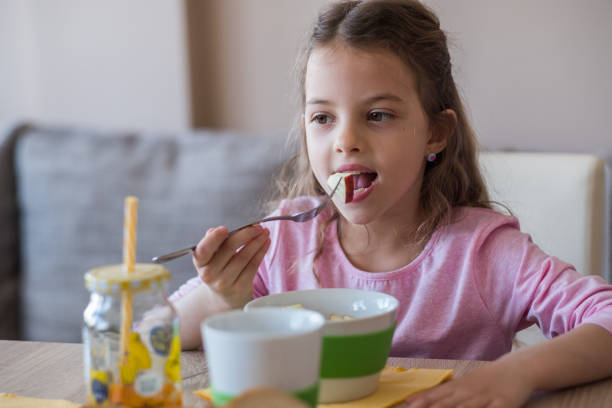 istock Girl eats fruits 960907420