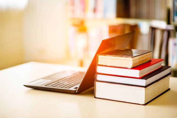 istock Bookshelves and laptops are placed on the library desk. 960910984