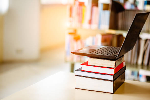 istock Bookshelves and laptops are placed on the library desk. 960910992