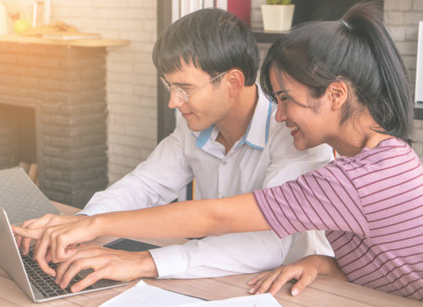 istock Happy Couple is using laptop working together at home 960915610