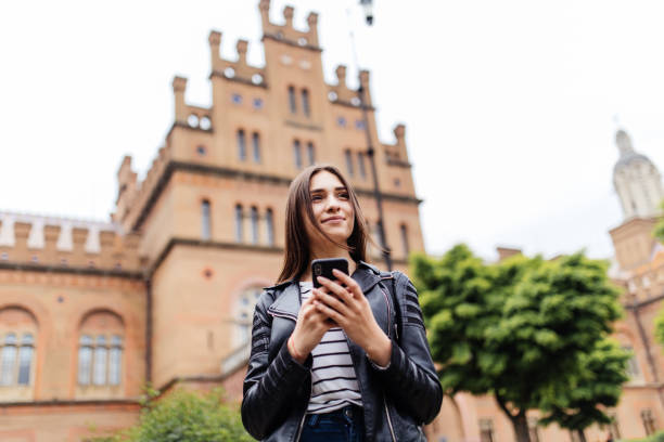 istock Cute young female college student using smart phone browsing internet in campus 960922044