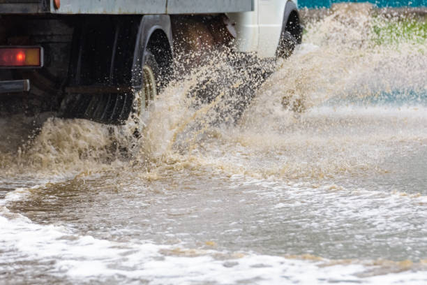 istock car rain puddle splashing water 960922160