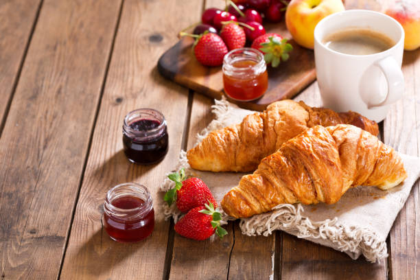 istock breakfast with croissants, coffee and fresh fruits 960924082