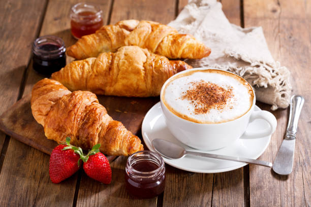 istock Breakfast with cup of cappuccino coffee with croissants 960924096