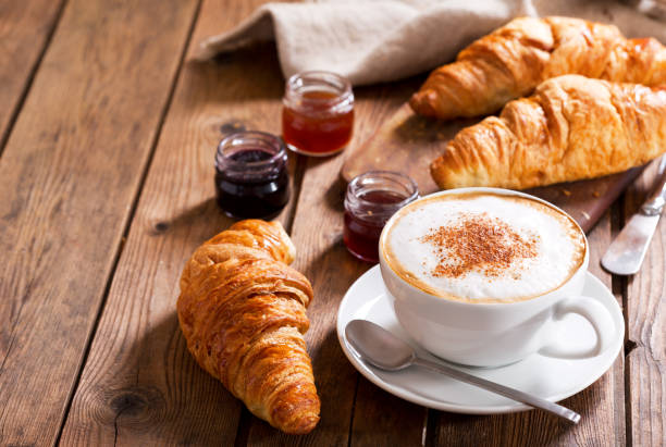 istock Breakfast with cup of cappuccino coffee with croissants 960924098