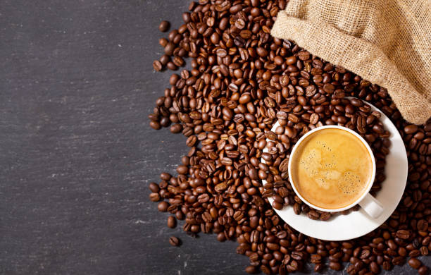 istock cup of coffee and coffee beans in a sack, top view 960924178