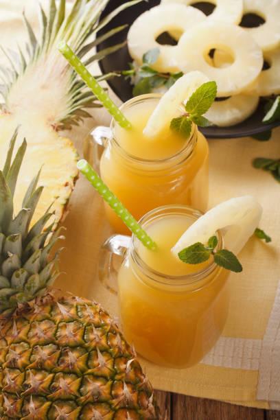 istock freshly squeezed pineapple juice in a glass jar closeup. vertical 960931060