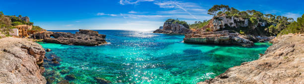 Picturesque coast panorama on Majorca island, view of bay beach Cala S'Almunia, Spain Mediterranean Sea Idyllic view of coastline panorama Cala S'Almunia bay, beautiful seaside on Mallorca island, Spain balearic islands stock pictures, royalty-free photos & images