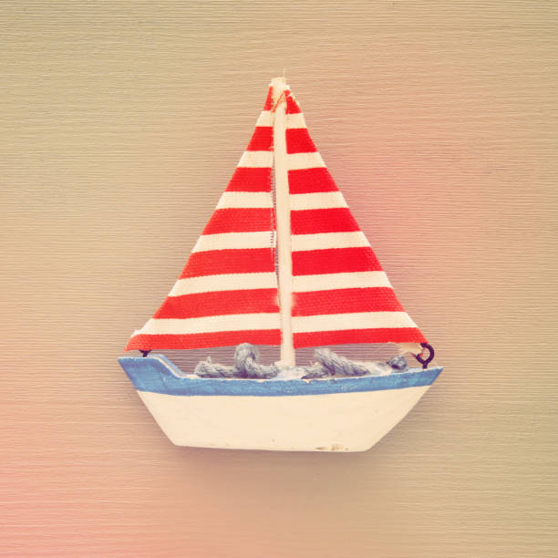 vacation and summer image with boat over wooden background