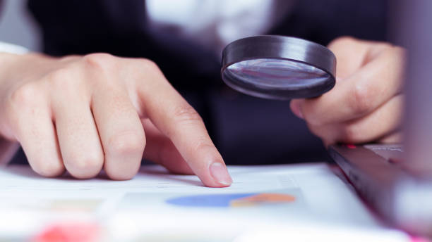 istock Business Analysis and Statistics Reports from sales charts last year using a magnifying glass. 960931812