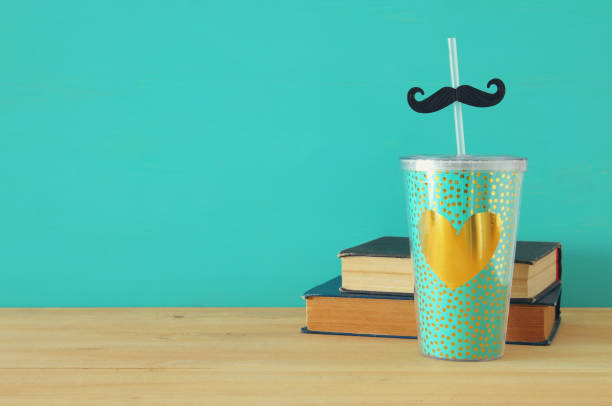 istock Image of plastic cup with golden heart. Father's day concept. 960931926