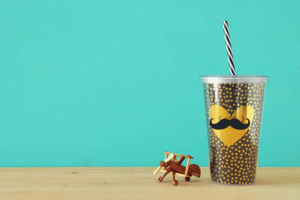 istock Image of plastic cup with golden heart. Father's day concept. 960931946